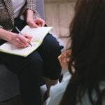 Psychologist taking notes during a clinical assessment
