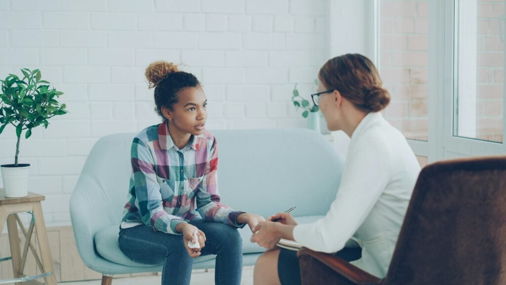 Psychologist completing a mental state examination template during a client session